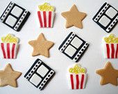 decorated cookies are arranged in the shape of popcorns and film strips with stars on them