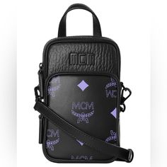 New With Tags! Unisex Mcm Black Leather Color Splash Logo Mini Crossbody Bag This Petite Crossbody Bag By Mcm Is Crafted Of Both Pebbled & Smooth Leather W/ Sleek Matte Hardware. The Classic Two-Toned Monogram Print Appears On The Front Zipper Pocket. A Tonal Logo Plaque Completes The Look. Approx. Size: 6” X 9” X 4” Details: Contrast Color Logo Detailing Black Matte Hardware Top Handle W/ 1.5” Drop Removable/Adjustable Crossbody Strap Top Zip Closure Exterior Front Zip Pocket Black Cotton Twill Designer Black Shoulder Bag Pouch, Luxury Black Belt Bag With Mobile Phone Holder, Luxury Black Phone Bag With Detachable Strap, Black Luxury Pouch With Detachable Strap, Luxury Black Pouch With Detachable Strap, Luxury Black Bags With Cell Phone Pocket, Luxury Black Bag With Cell Phone Pocket, Luxury Black Phone Bag With Adjustable Strap, Designer Black Crossbody Belt Bag