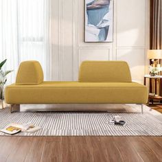 a yellow couch sitting on top of a wooden floor