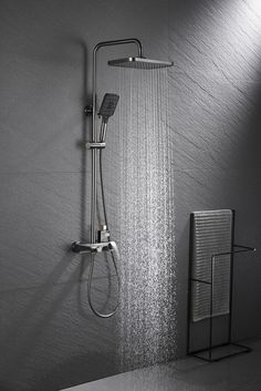 a shower head with thermostaer and hand held showerhead in black and white