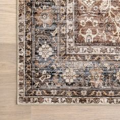 an area rug is shown on a wooden floor with a light brown and blue color scheme