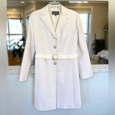 Ann Taylor 100% Cotton Coat Size 10 Removable Belt Ribbed White / Ivory / Cream Two Front Pockets Four Buttons Down Front Four Buttons On Each Sleeve Cuff Collared Flattering Silhouette Minor Wear Present Armpit To Armpit: ~20” Length From Shoulder: ~35” If You Are Brand New To Poshmark, Use Code Cem_poshmark At Checkout For $10 Off Your First Order. Tailored White Career Blazer, White Tailored Career Blazer, White Tailored Blazer For Career, Elegant White Outerwear For Business Casual, Tailored White Outerwear For Work, Fitted White Outerwear For Work, White Long Sleeve Blazer For Career, Single Breasted White Outerwear For Business Casual, White Spring Outerwear For Business Casual