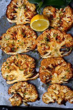 grilled cauliflower steaks with lemon wedges and parsley on the side