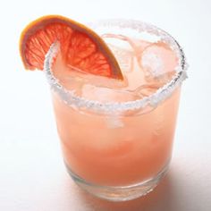 an orange slice is placed on top of a drink