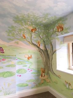 a child's room with a tree painted on the wall