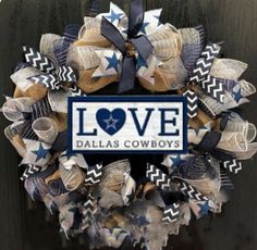 a wreath with the word love on it that says love in blue and white stars