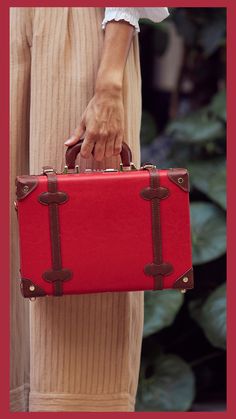 Vintage-Inspired Luggage in Red with Brown Accents from SteamLine Luggage, made with Vegan Leather | The Entrepreneur is one of our most beloved collections. Every inch an original, the vegan-leather design will inspire your most creative business mind as you blaze a trail between doors | The Entrepreneur by SteamLine Luggage | Travel Essentials, Vintage Outfit Inspiration | Adventure Travel Inspiration & Luxury Luggage Sets | #luxuryluggage #travelinspo #vintage #womensstyle #womensfashion