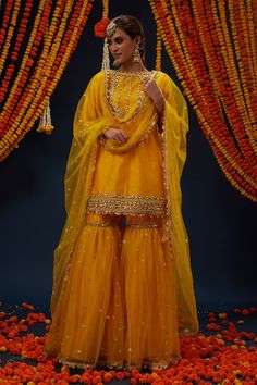 Cadmium yellow kurta with gota embroidery. Comes with gharara and a dupatta.
Components: 3
Pattern: Embroidered
Type Of Work: Gota
Neckline: Boat Neck
Sleeve Type: Three quarter
Fabric: Kurta : Dupion, Gharara : Dupion and Net, Dupatta : Net, Lining : Shantoon
Color: Yellow
Other Details: 
Closure : Side zip
Occasion: Mehendi and Haldi - Aza Fashions Yellow Sharara For Haldi, Mehndi Gharara, Yellow Gharara, Mehendi Dresses, Yellow Sharara, Gharara Designs, Haldi Dress, Cadmium Yellow, Yellow Kurta