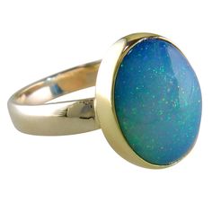 An oval shaped Ethiopian opal is bezel set as the centerpiece of this ring. Why Opal? Because opal has the colors of other gems, the Romans thought it was the most precious and powerful of all. The Bedouins believed that opals contained lightning and fell from the sky during thunderstorms. 22K Yellow Gold Bezel 14K Yellow Gold Shank (3mm) Oval Ethiopian Opal (Pinfire) Top of ring measures 15mm x 12.5mm Size 6 Weighs approximately 4.9 grams Signed by artists KJD 22K 14K (Kevin & Joanne Dowdy) Oval Gold Ring, The Romans, Fashion Capsule, Druzy Ring, Bezel Setting, Ethiopian Opal, Capsule Wardrobe, The Sky, Gold Ring