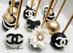 black and white cake pops decorated with gold forks, flowers and chandelier pins