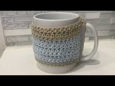 a crocheted coffee cup is sitting on the counter