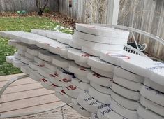 several stacks of paper towels stacked on top of each other in front of a fence