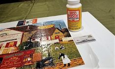 a bottle of medicine sitting on top of a table next to a piece of paper