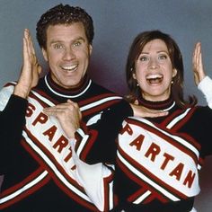 a man and woman in cheerleader outfits posing for the camera with their hands up