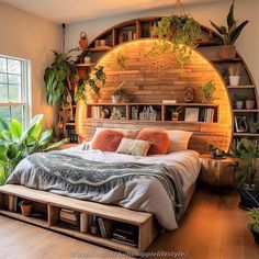 a large bed sitting under a window next to a wooden shelf filled with potted plants