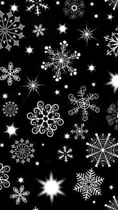 black and white snowflakes are flying through the air with stars in the background