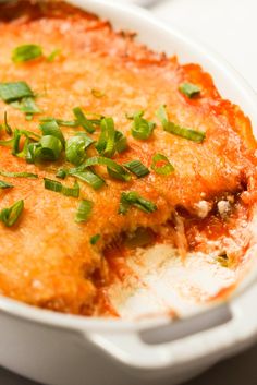 a casserole dish with cheese and green onions