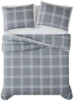 the comforter is made up with grey and white plaid sheets, pillows, and pillowcases