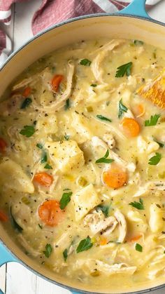 a pot filled with chicken and dumplings on top of a table