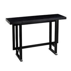 a black wooden table sitting on top of a white floor