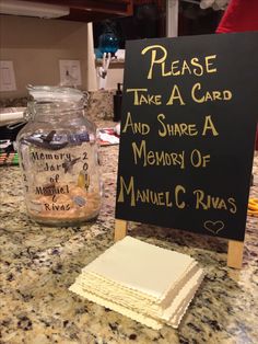 a sign that says please take a card and share a memory of manuell c rivas