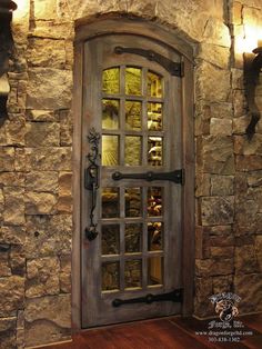 a stone wall with a wooden door and glass inserts