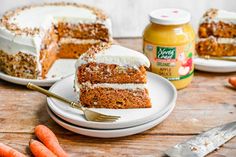 carrot cake with cream cheese frosting and sliced carrots next to it on plates