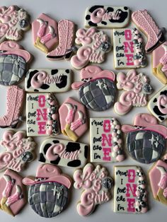 decorated cookies with pink and black designs on them are arranged in the shape of hearts