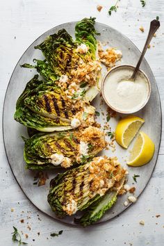 grilled artichokes with lemon and parmesan dressing on a plate