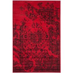 a red and black rug with an ornate design on the bottom, in front of a white background