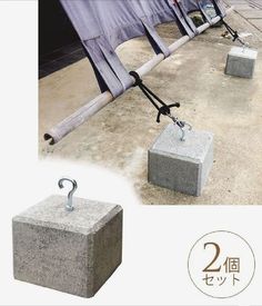 there are two cement blocks with hooks attached to them