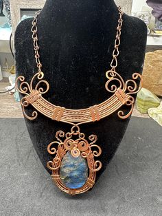 a necklace with a blue stone on it