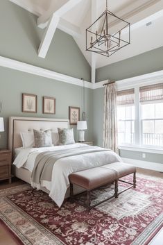 a bedroom with a large bed sitting on top of a rug next to a window