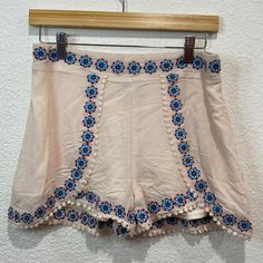 Blue Rain Bohemian Embroidered Scalloped Shorts Back Elastic Waist Size: M Measured On A Flat Surface: Unstretched: Approx: Waist: 14 1/2” Summer Cream Bottoms With Floral Embroidery, Cream Floral Embroidery Bottoms For Summer, Summer Floral Embroidery Cream Bottoms, Cream Bohemian Bottoms For Vacation, Bohemian Cream Bottoms For Vacation, Beige Floral Embroidered Bottoms For Spring, Spring Beige Floral Embroidered Bottoms, Summer Cotton Bottoms With Embroidered Hem, Summer Festival Bottoms With Tassels