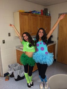 two young women dressed in costumes standing next to each other and posing for the camera