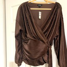 Faux Wrap Bronze Blouse From Express. Comfortable And Can Be Dressed Up Or Worn With Jeans. Long Sleeve Faux Wrap Blouse For Fall, Chic Faux Wrap Blouse For Fall, Faux Wrap Long Sleeve Blouse For Fall, Faux Wrap Long Sleeve Fall Blouse, Faux Wrap Top For Night Out In Fall, Elegant Brown Blouse For Night Out, Elegant Brown Tops For Date Night, Elegant Brown Top For Date Night, Brown Long Sleeve Blouse For Party