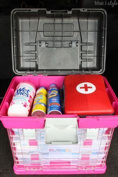 an open pink plastic container filled with supplies