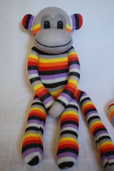 a sock monkey sitting on top of a bed