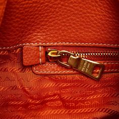 This hobo bag was made from orange leather. It features an open top with magnetic snap closure. The gold-tone details give the Bag touch of elegance. It is carried on the shoulder by the rolled/braided leather handle. The interior features a zippered side compartment. Prada Hobo Bag, Prada Hobo, Miuccia Prada, Orange Bag, Orange Leather, Vuitton Bag, Bag Bag, Braided Leather, Open Top