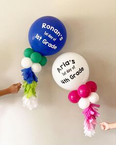 balloons with writing on them are being held by children