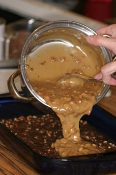 a person pouring something into a bowl on top of a table