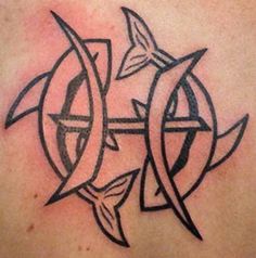 a tattoo on the back of a woman's shoulder with an arrow and fish