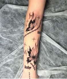 a woman's arm with two butterflies on it and the words tattoo written in black ink