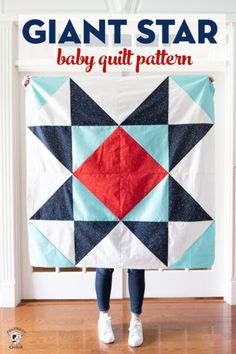 a person holding up a quilt with the title giant star baby quilt pattern on it