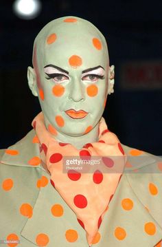 a mannequin with orange and red polka dots on it's face