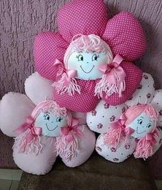 pink and white stuffed toys are arranged in a pile on the floor next to a wall