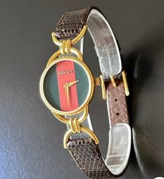 Gucci women's 6 1/2" wonderful gold timepiece with a new battery, original Gucci brown leather strap. with a stunning new crystal and a 22mm case (the dial is the size of a dime)  Model 60002l  and original owner, 100% authentic guaranteed with serial number 0123272 embossed @ back base and in great working condition. Please view my 100% positive reviews it tells my history. same day secure, fast shipping, Thank you for your consideration. Brown Analog Watches For Anniversary, Brown Anniversary Watches With Diamond Hour Markers, Gold Leather Round Watch, Gold Leather Watch For Anniversary, Designer Brown Watches With Diamond Hour Markers, Gold Leather Watches With Diamond Hour Markers, Gold Watch With Leather Strap And Round Dial, Gold Watches With Leather Strap And Round Dial, Designer Gold Watch Accessories With Metal Dial