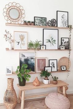 some shelves with pictures and plants on them in a living room or dining room area