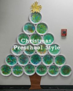 a christmas tree made out of paper plates with the words christmas preschool style on it