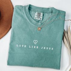 Are you a Jesus lover searching for the perfect gift? Look no further! Our faith-based apparel is designed to inspire and uplift those who follow Christ. Introducing our collection of faith-based shirts, a must-have for every Christian.  Product Info Comfort Colors Brand Shirt: 100% ring-spun cotton Care Instructions: Machine wash: cold (max 30C or 90F) Tumble dry: low heat Iron, steam or dry: medium heat Do not dry clean Production Time: Please allow 1 to 5 business days for production Delivery Jesus Loves You Shirts, Green Tops With Screen Print For Gift, Green Letter Print Top As A Gift, Green Letter Print Top As Gift, Inspirational Crew Neck Top As Gift, Green Screen Print Top As A Gift, Green Screen Print Top As Gift, Inspirational Letter Print Top As Gift, Christian Wear